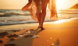 Young woman enjoying earthing at the beach.