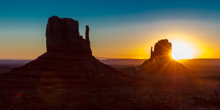 Sunrise over The Mittens Buttes helps highlight the spiritual significance of Monument Valley.