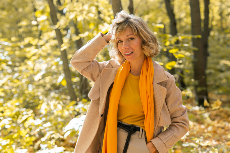 Beautiful mature woman on a gratitude walk in an aspen forest.