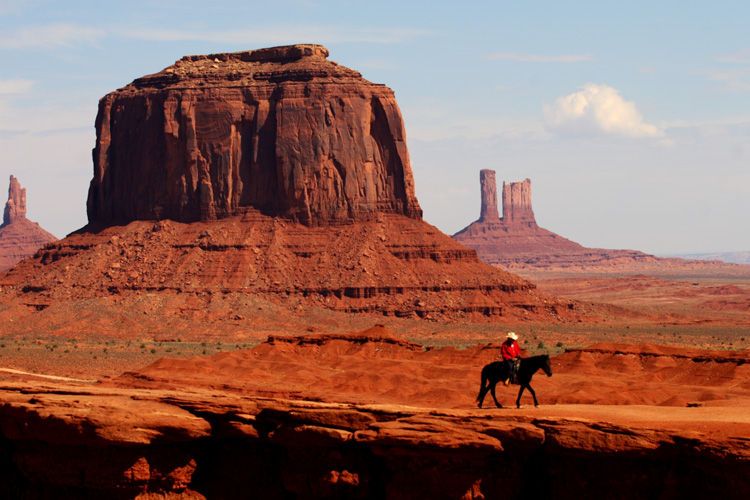 Navajo rides his horse through Monument Valley.