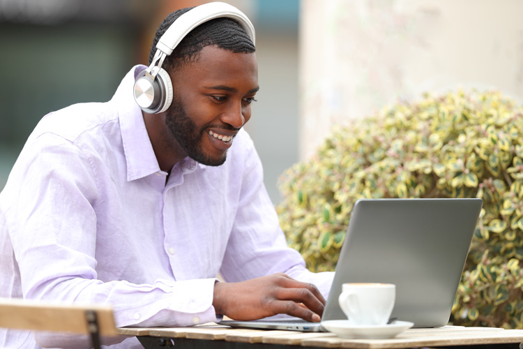 African-American writer accessing binaural beats to overcome writer's block. African-American writer accessing binaural beats to overcome writer's block.