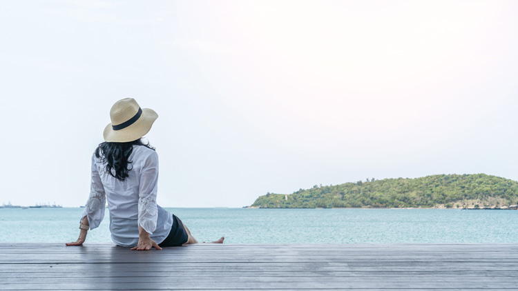 Young woman focused on her beach blue space.