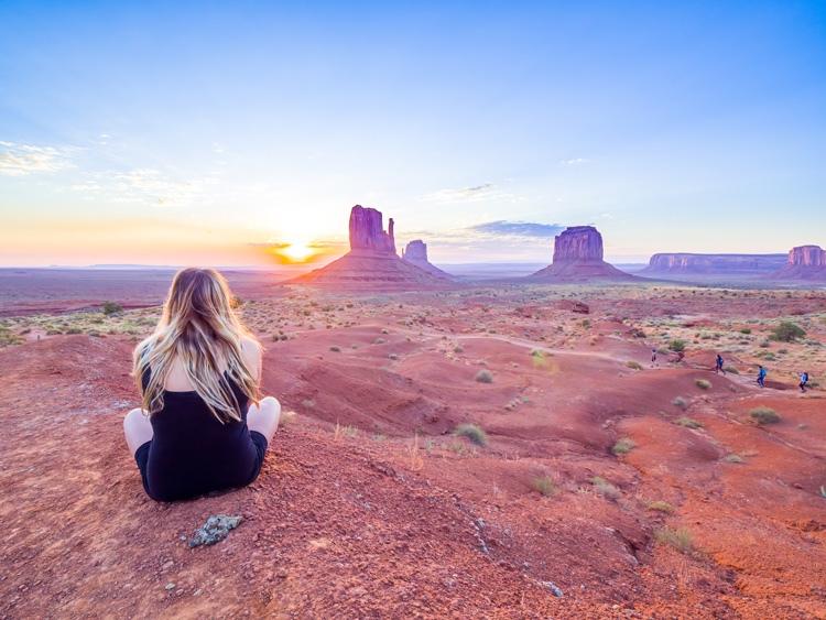Young woman meditates in Monument Valley.