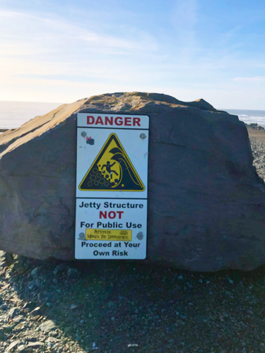 Sign at the jetty letting you know it is dangerous to walk out on this structure.