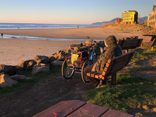 Some people come alone to watch the sunset on Thanksgiving Day on Rockaway Beach.