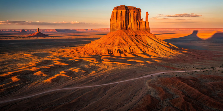 Sunrise over Monument Valley Mitten rock formation.