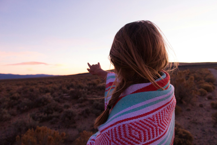A young woman experiencing the spiritual significance of Taos New Mexico.