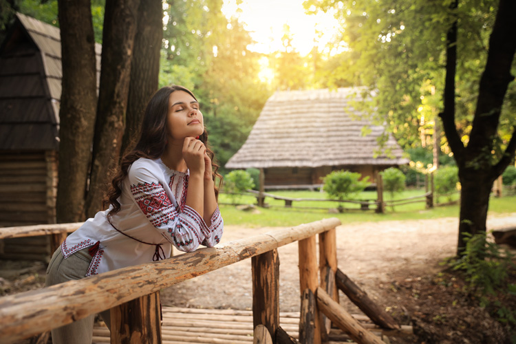 Young woman is prayerful in a vintage mission near Taos. Young woman is prayerful in a vintage mission near Taos.