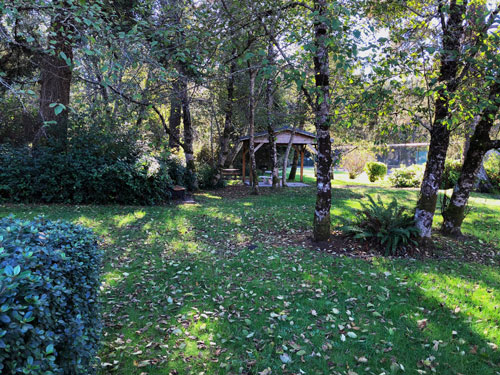 A stretch of beautifully maintained lawn will take you down to a covered picnic table.