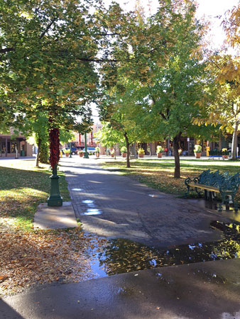 Rain puddles give a sense of peace to Santa Fe Plaza.